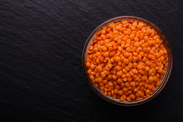 raw lentils on a dark stone background