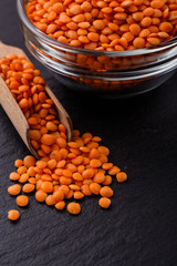 raw lentils on a dark stone background