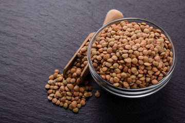 raw lentils on a dark stone background