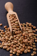 raw lentils on a dark stone background