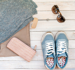 Sneakers, glasses, female handbag, hairpin and piece of jewelry - preparation for a travel