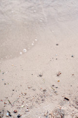Transparent sea water against the background of yellow sand