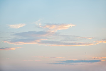 Beautiful clouds at sunset against the background of the blue sky