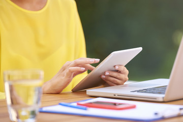 Close-up of woman using digital tablet