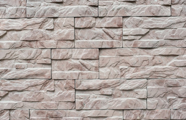 A wall of brown stone. Stone wall texture background natural color