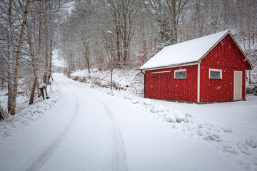 Fototapeta na wymiar Winter scenery with red wooden house in Sweden