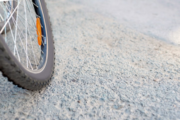 Wheel of the bike on the street, the idea for a sport bike is on the road. bicycles are on the road