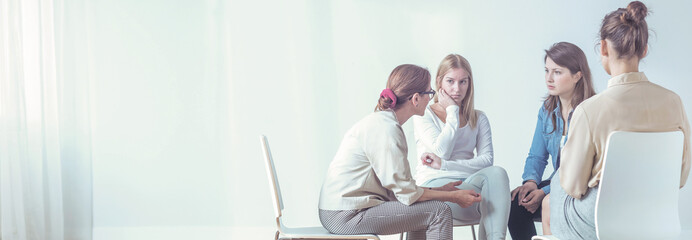 Women listening to a therapist during a session. Empty space, place your poster