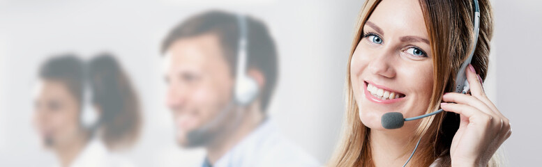 Close-up of a woman working in a call centre - obrazy, fototapety, plakaty