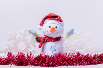 Funny snowman with big snowflakes from foam on a white background