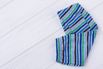 Folded striped clothes for children.