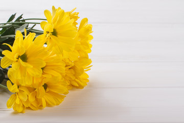 Beautiful yellow flowers on white wooden background. Close up. Sunchoke flowers.