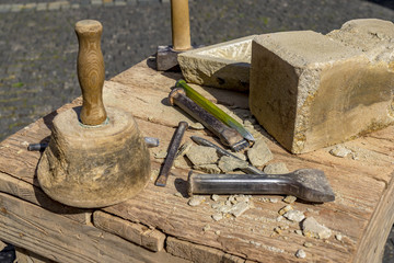 Stonemason tools hammer and chisel outdoors.