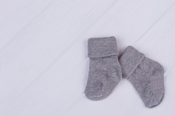 Wool kid socks on wood with copyspace.