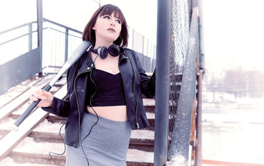 Obraz premium Girl in headphones listening to music outdoors