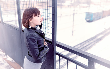 Obraz premium Girl in headphones listening to music outdoors