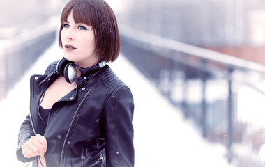 Obraz premium Girl in headphones listening to music outdoors