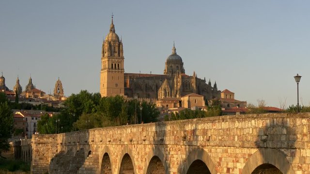 Salamanca Cathedral and old Bridge at sunset. Castile and Leon, Spain. Panning shot, 4K