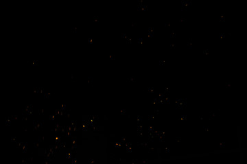 bonfire spark in the dark sky in night, shallow focus