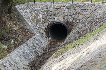 Trough the pipe.