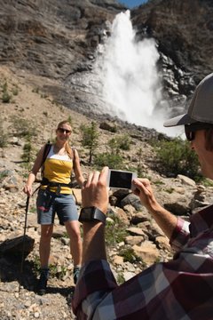 Man clicking photo ow woman with mobile phone