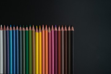 color pencils on black background close up..