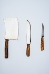 top view of set of various kitchen knives isolated on grey
