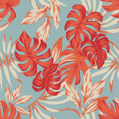 Tropical autumn leaves blue background