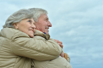 Portrait of happy senior couple hugging in park