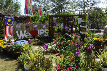 PUTRAJAYA, MALAYSIA -AUGUST 26, 2018: Small pocket garden made from mix of recycle material and flowers at Floria Garden, Putrajaya, Malaysia. 