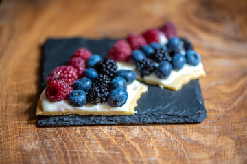 Delicious raspberry cake with fresh strawberries, raspberries, blueberry, currants