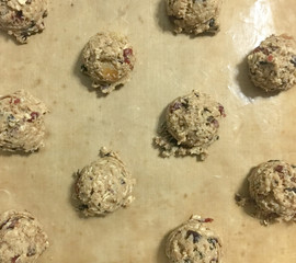 Raw cookie dough on the baking teflon sheet.