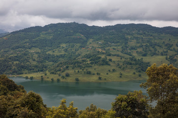 Fototapeta na wymiar Cloudy Himalayan valley and lake