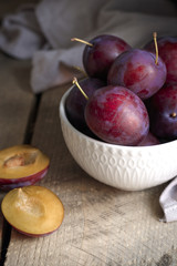 fresh plums on wooden table
