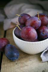 fresh plums on wooden table