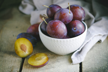 fresh plums on wooden table