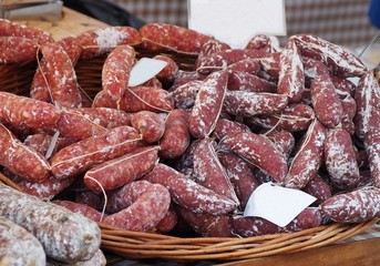 Sausages of wild boar tied together, specialties of Tuscany, in an outdoor market