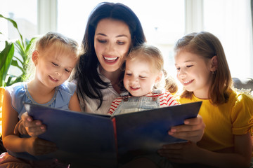 Mom and children reading a book