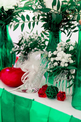 Soccer and pole sport dancer wedding decor in Eco rustic style with green ribbons, red candles, bottles, white flowers and green leaves.