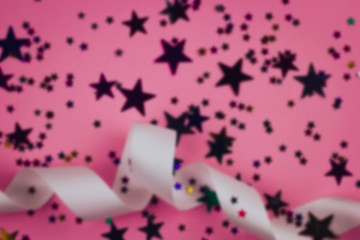 blurred festive backkdrop with satin ribbon and stars