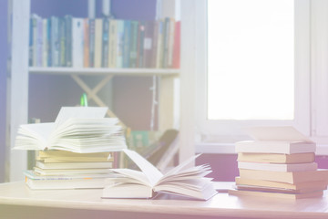 books on the table  blurred background of the bookcase