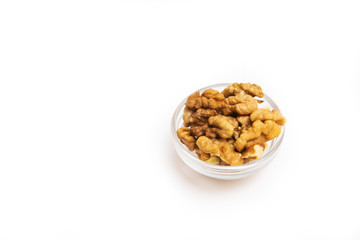 Walnuts in small bowl and inscription vitamins on yellow background