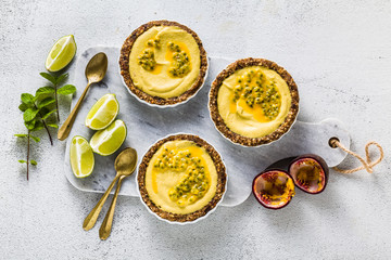 vegan raw mini tarts from nuts and dates with cashew cream from mango purée with lime juice and...