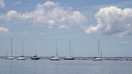 sail boats on reflective water