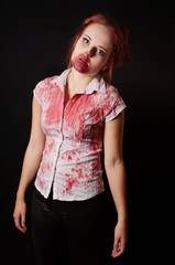 female zombie with bloody mouth and blouse on black background