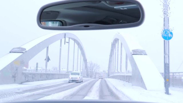 Driving on snowy and frosty bridge in Lubeck.