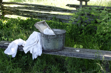 Pioneer washing board with white laundry outside in summer
