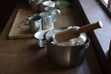 Pioneer kitchen tools with egg shells on wooden table