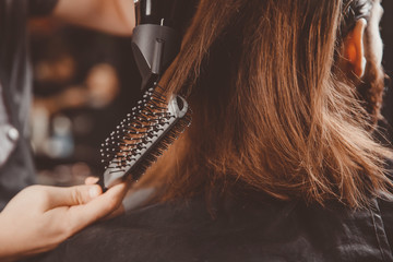 Hairdresser for men barber shop. Process of grooming long hair.