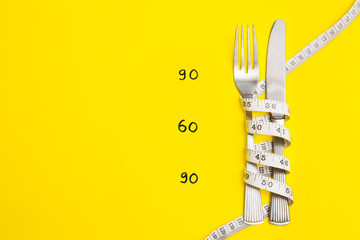 Knife and work with centimeter on yellow background